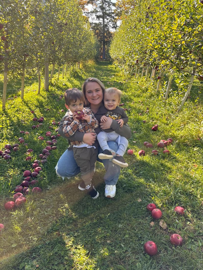 Picture of Brittany DiMarzio in an apple orchard with her two kids